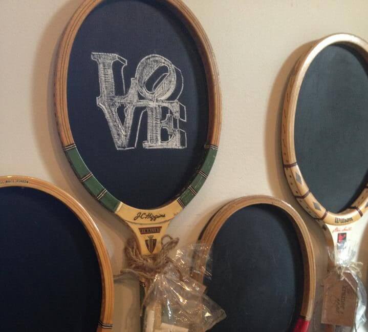 Tennis rackets can be upcycled and used as chalkboards.