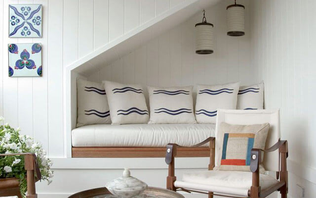 Diván en el hueco de debajo de la escalera.