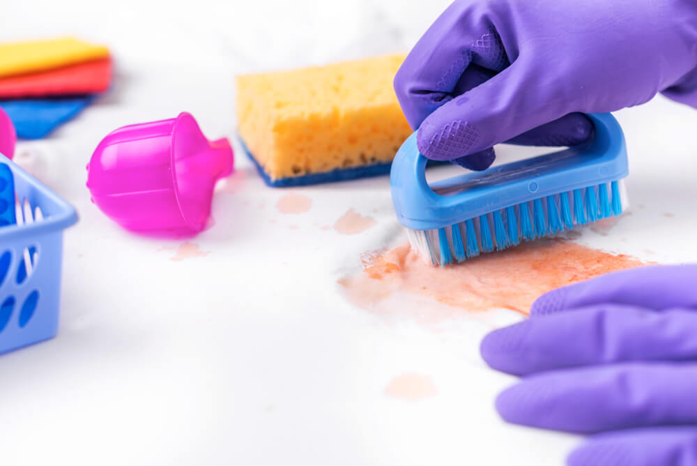 Remove stains from clothes before putting them in the laundry.