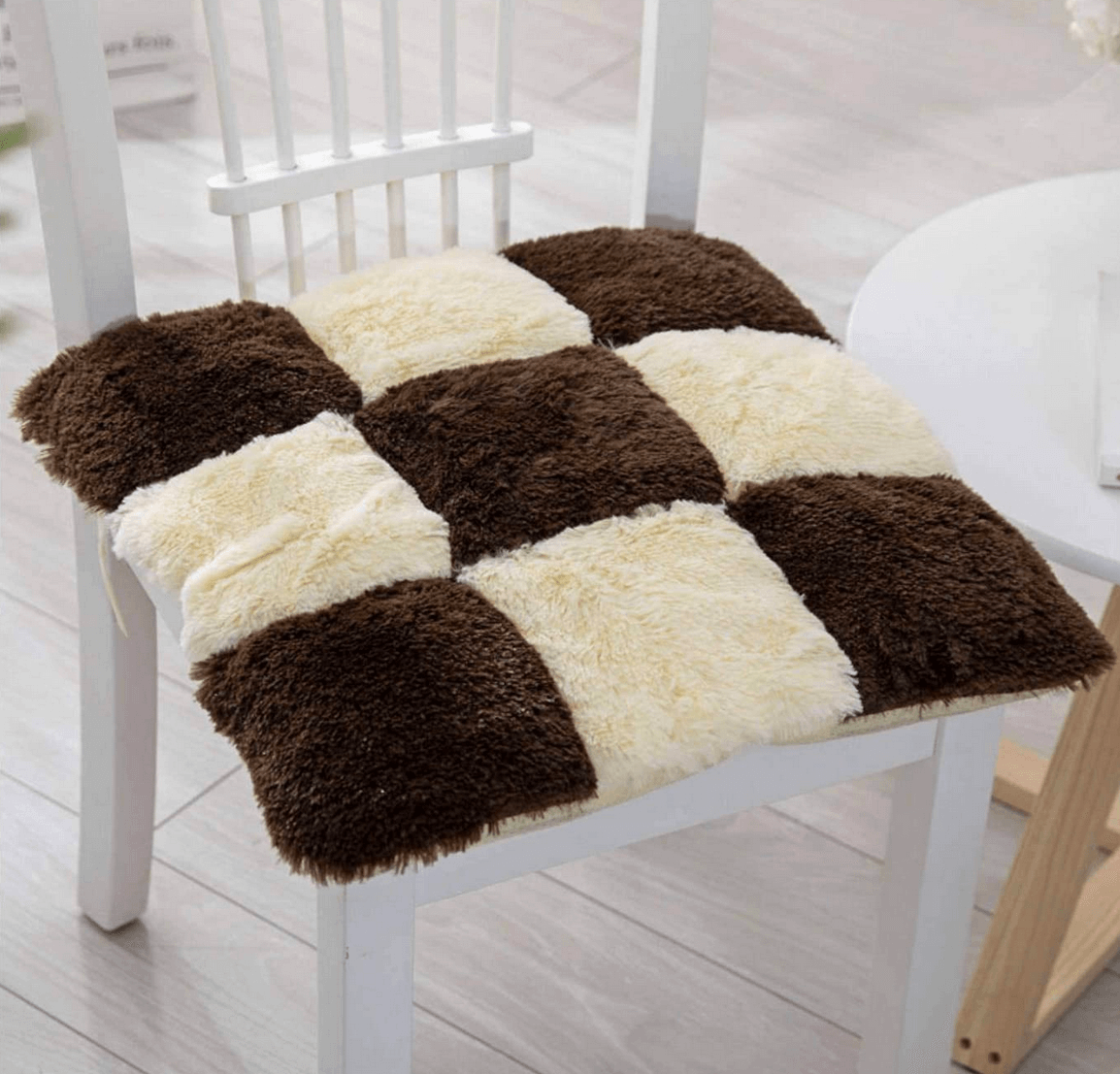 A wooden kitchen table chair with a brown and cream checker-patterned seat.