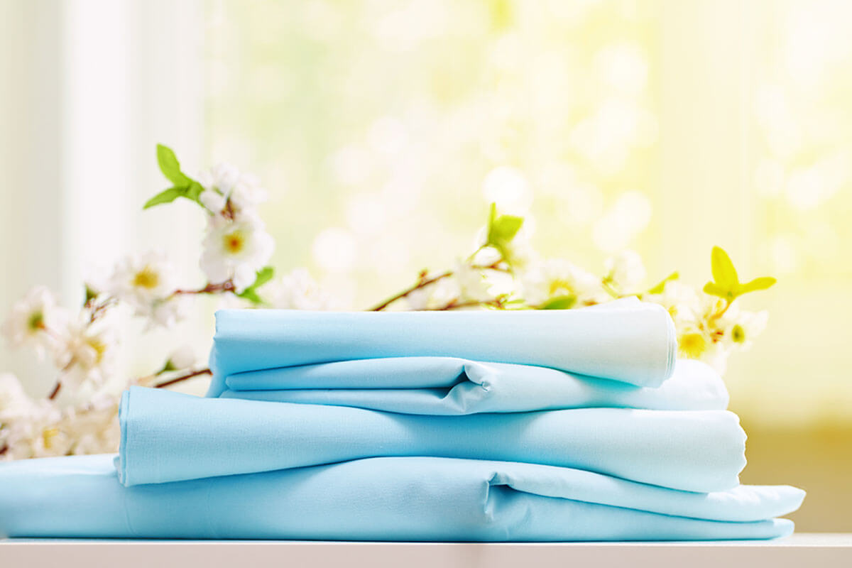 Swap out the bedding for a cooler one.